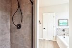 Master Bathroom Features Bathtub and Standing Shower